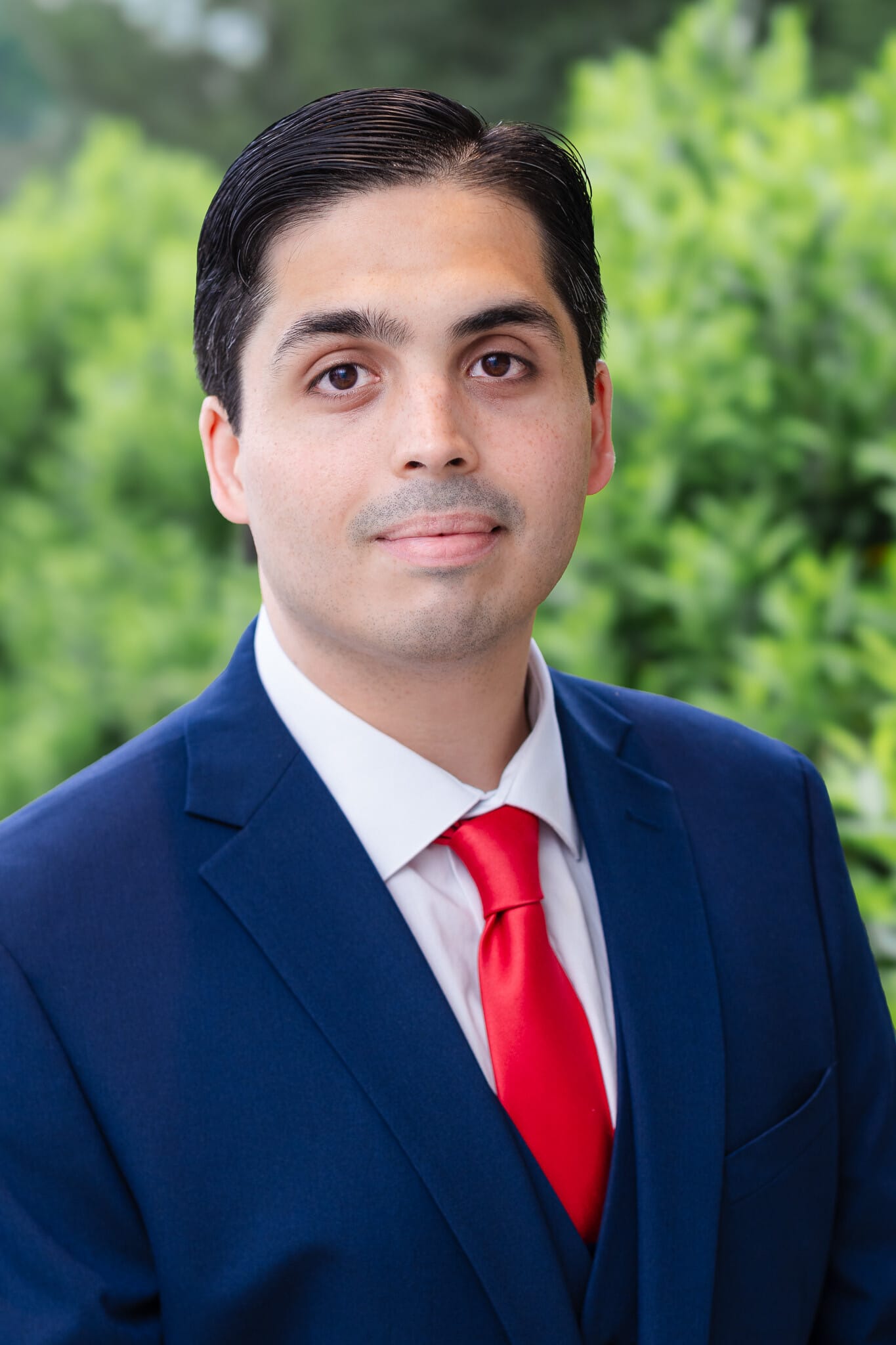 Professional headshot, natural light, outdoor