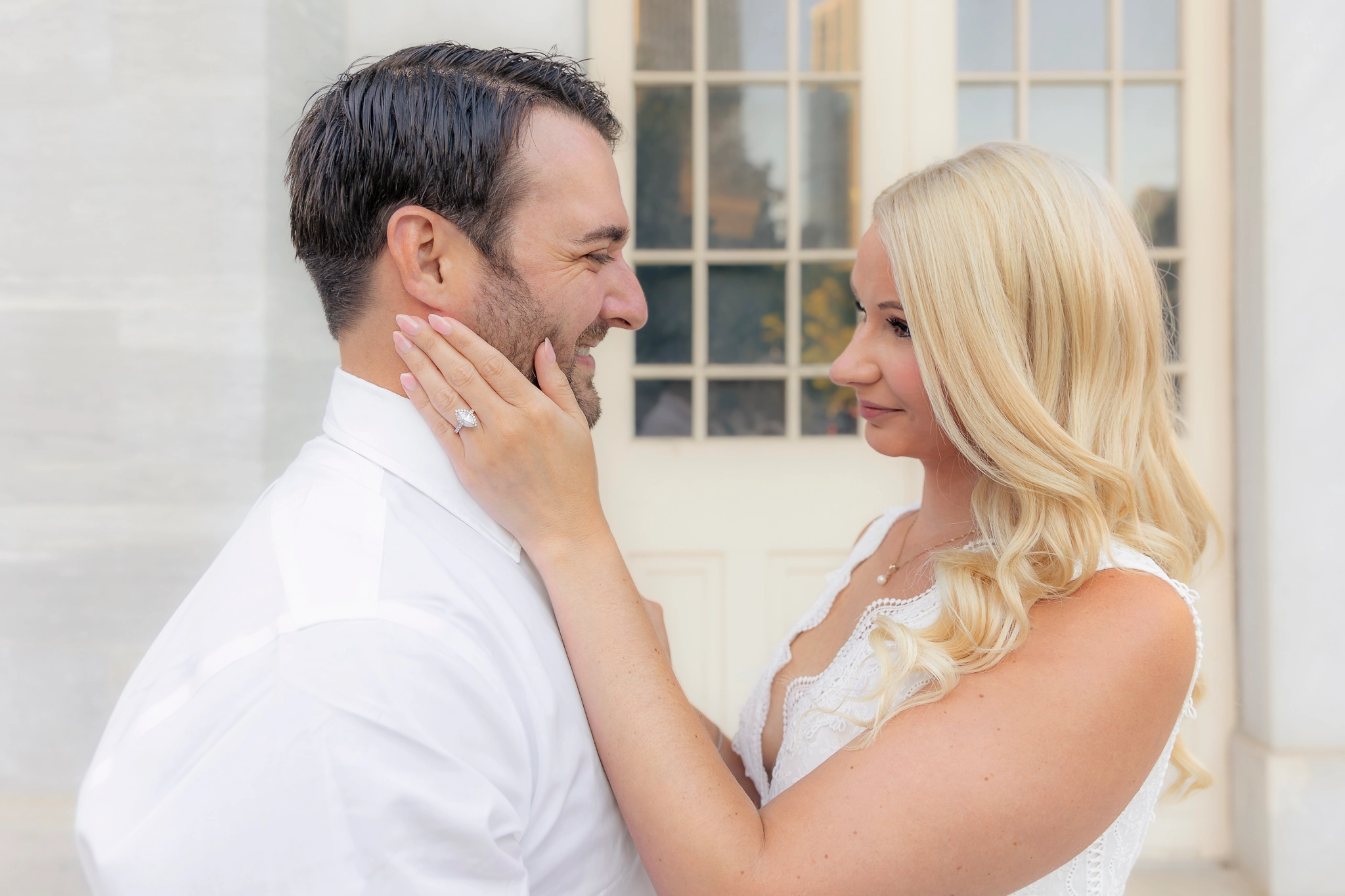 Philadelphia couple posing for engagement photos at the Merchant Exchange Building in Old City.
