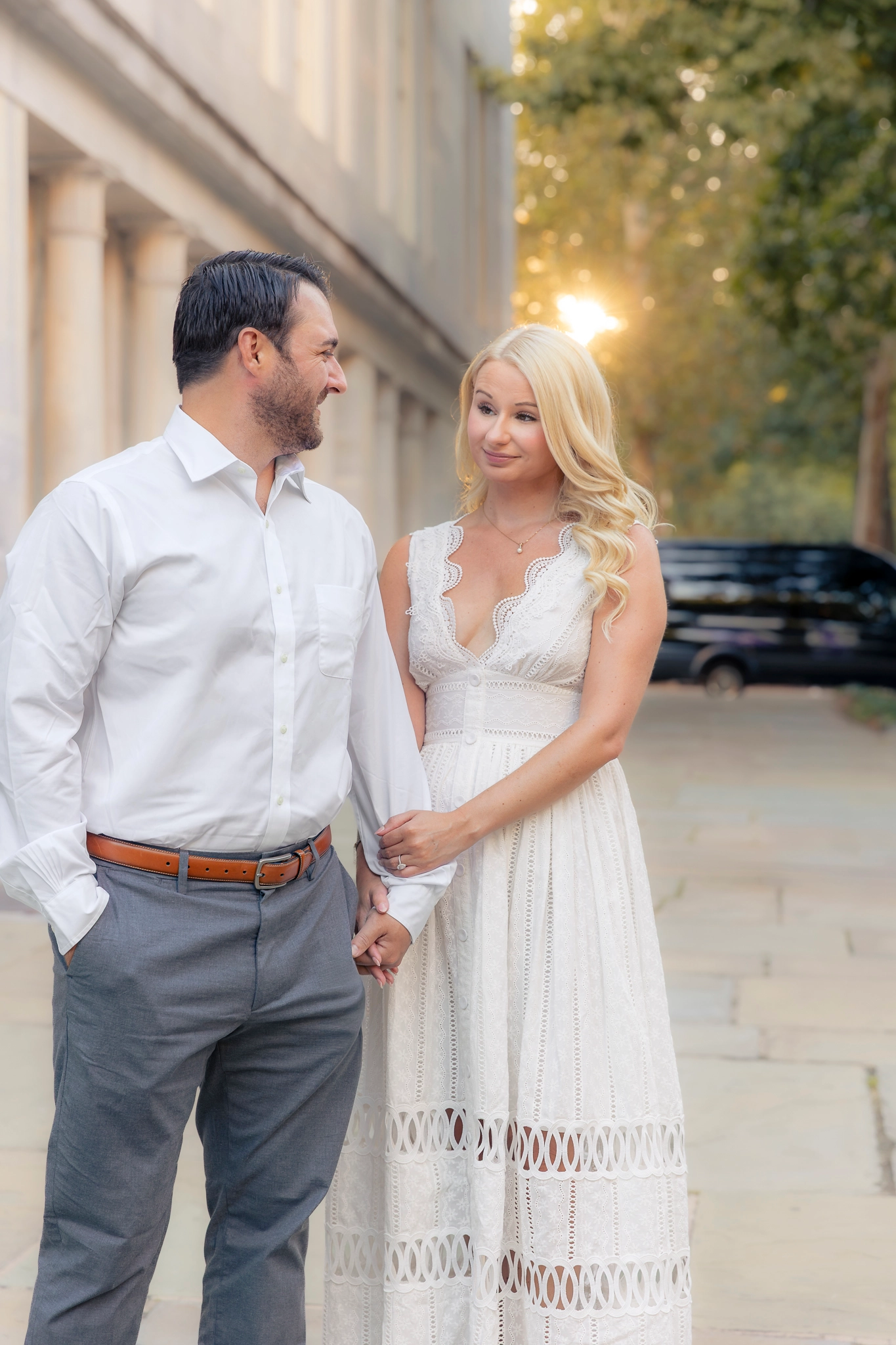 Couple smiling during their Philadelphia engagement photos at the Merchant Exchange Building in Old City.